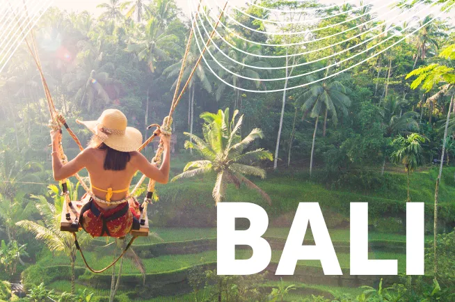 Frau mit Hut schaukelt auf Bali über Reisplantage